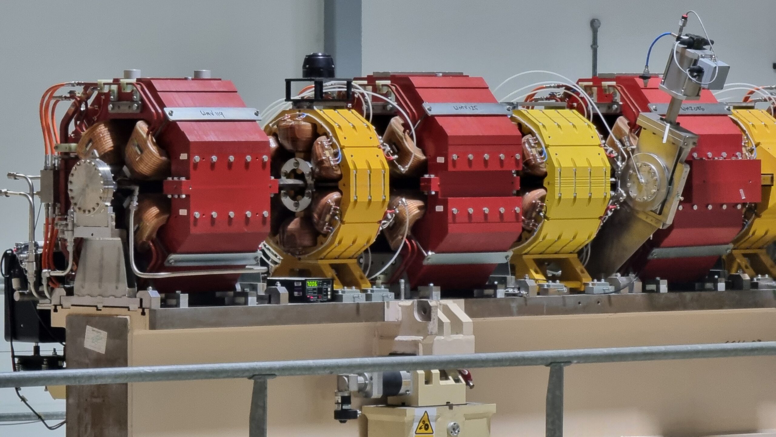 Full image of String of large electromagnets used for steering an electron beam.