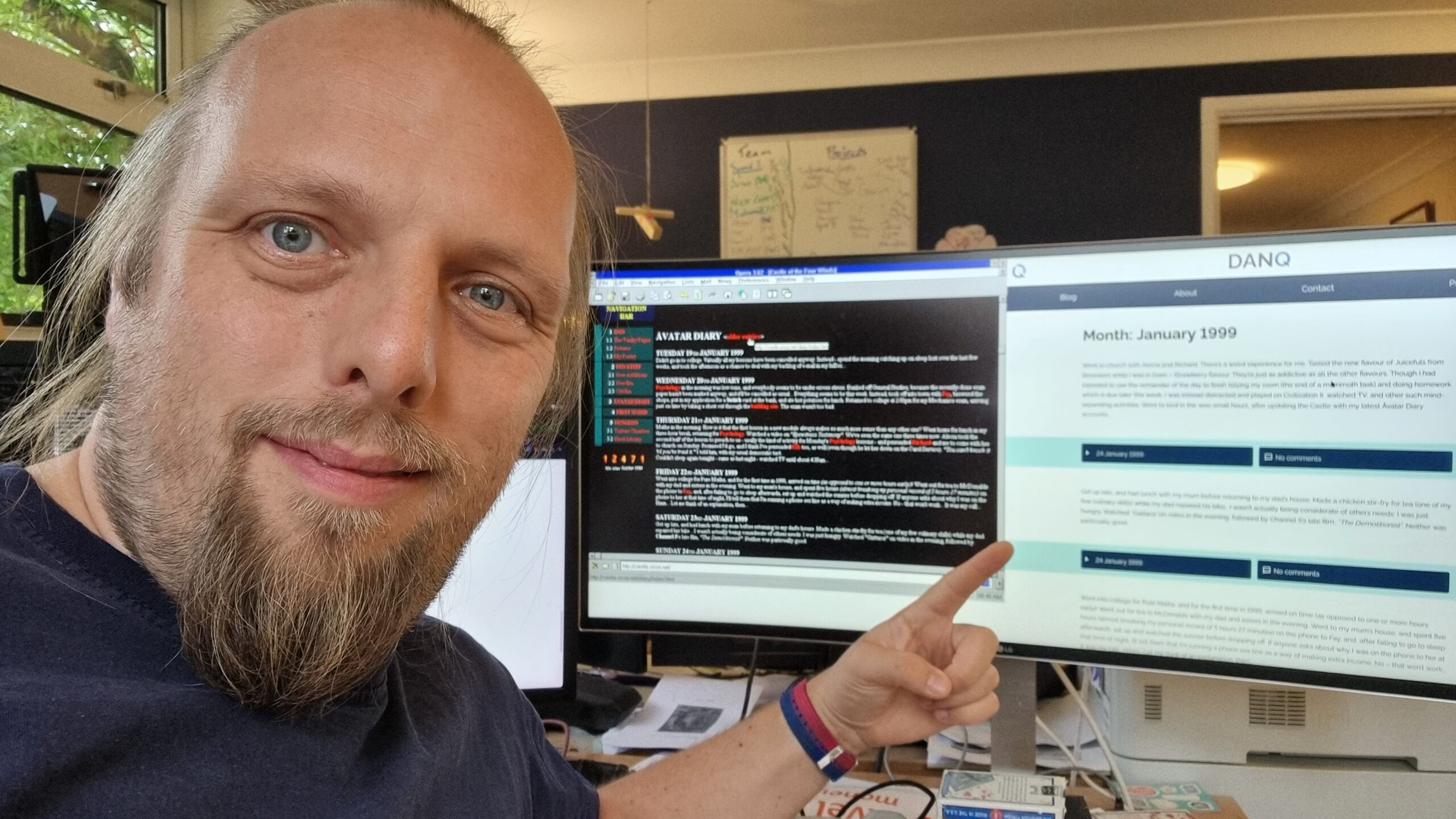 Full image of Dan poses in front of circa 1999 and present-day copies of his blog, both showing posts from January 1999.