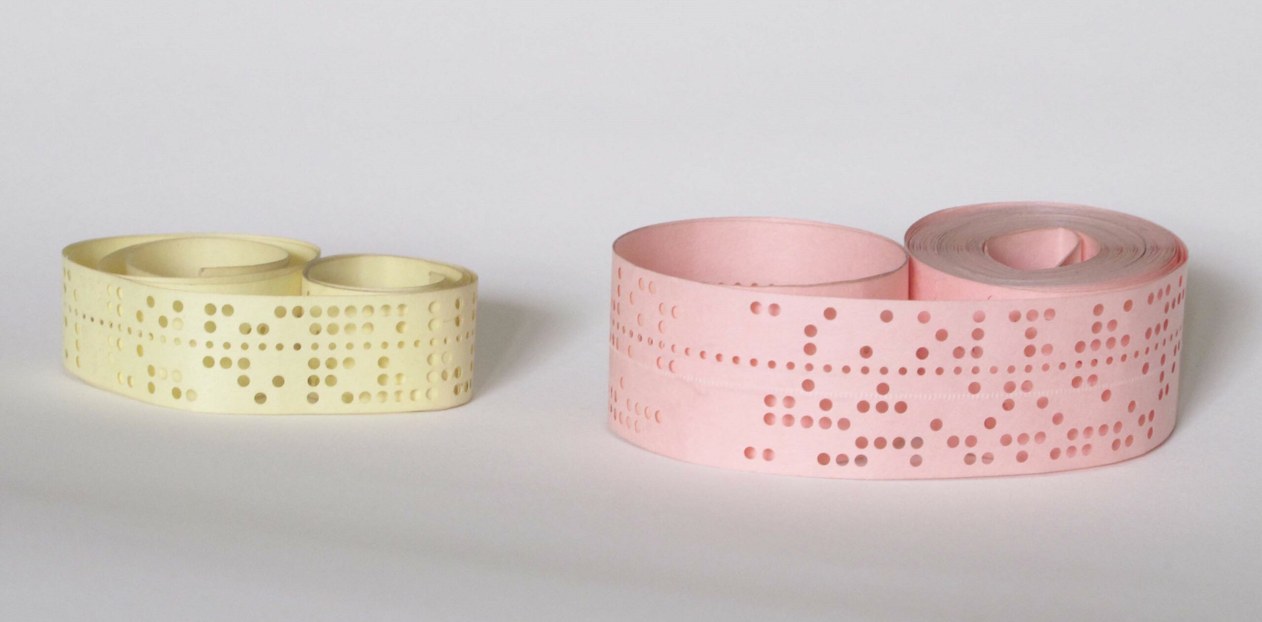 Full image of Two rolls of punched paper tape.