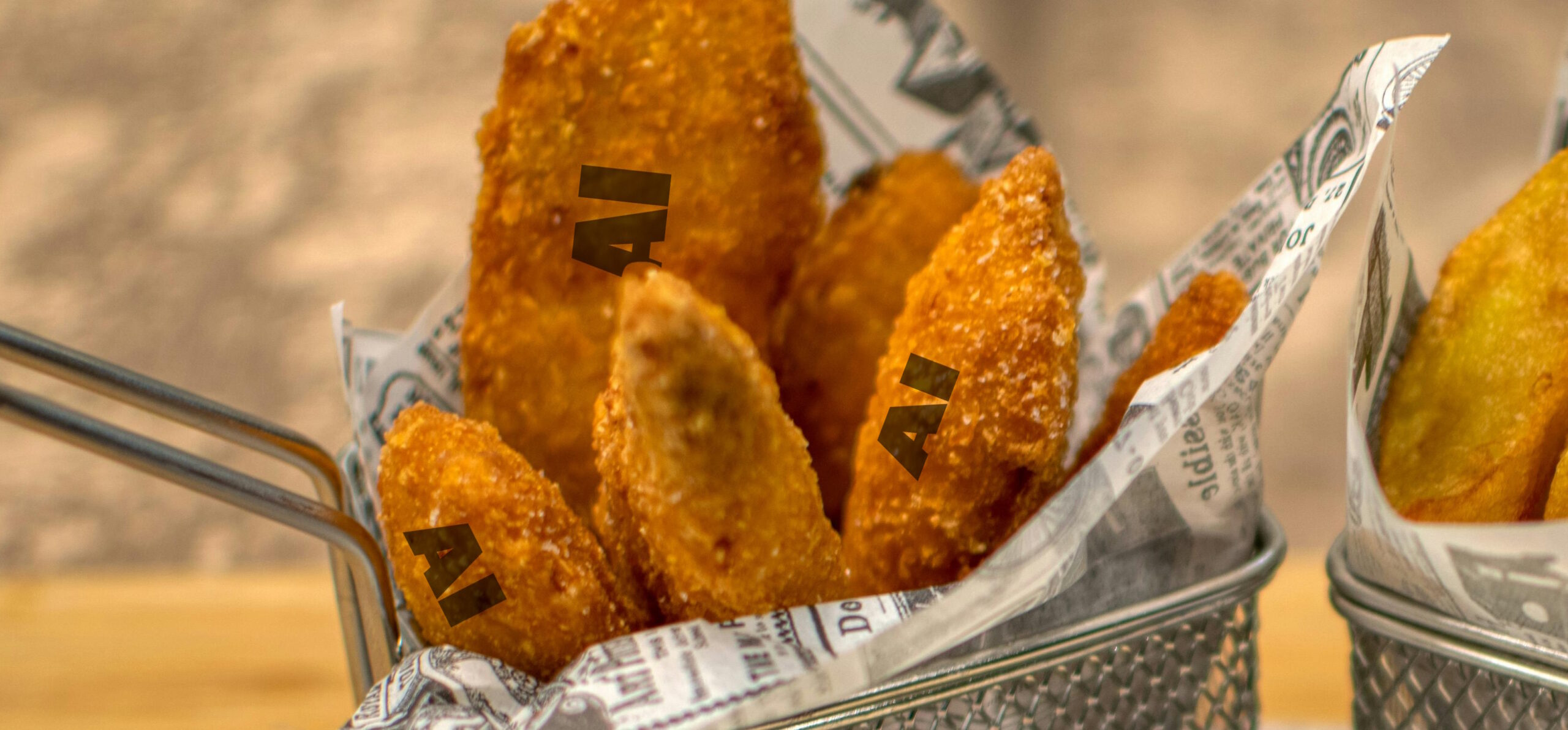 Full image of Photo of chicken nuggets with "AI" written on each of them.
