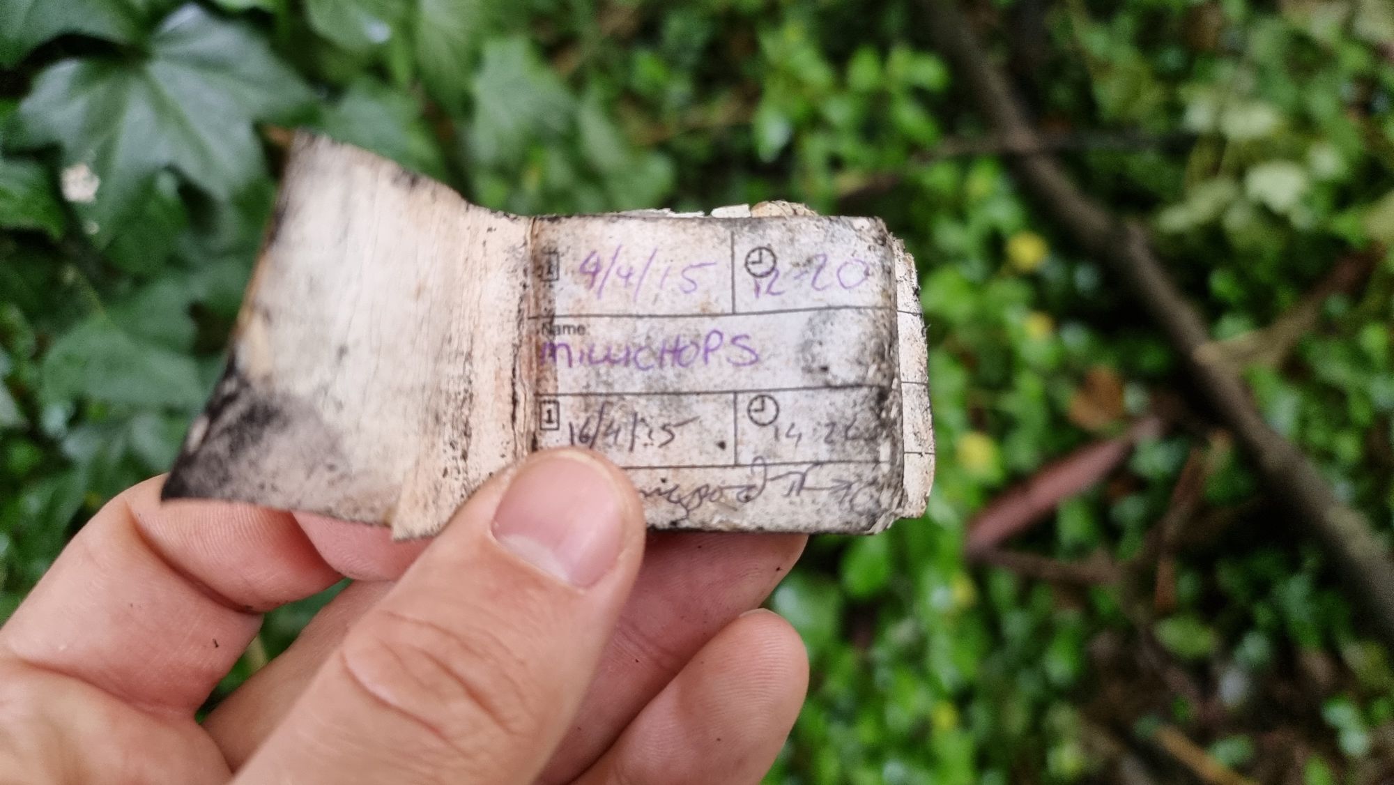 Full image of Damp geocaching log book,open.