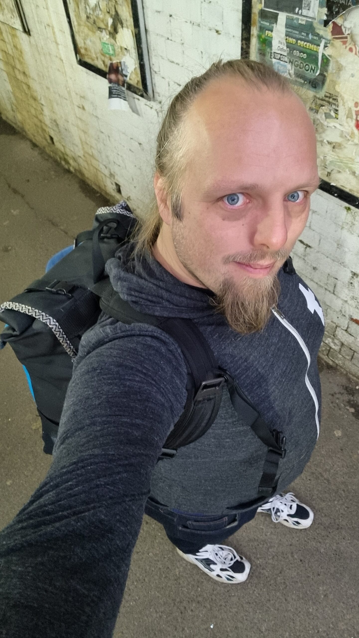 Full image of Selfie of Dan in a tunnel walkway wearing a backpack.