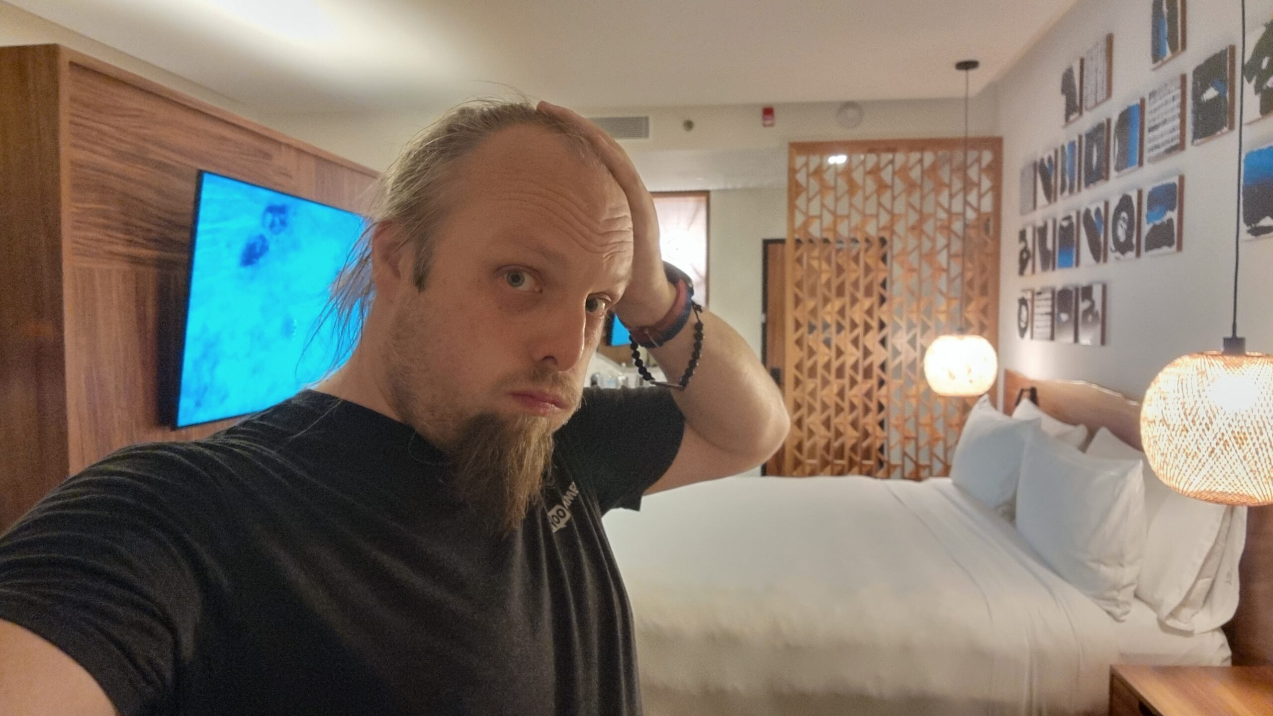 Full image of Dan, looking tired, in a hotel room.