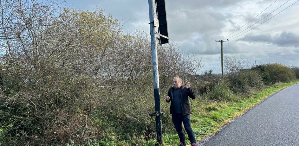 Dan stands by an old fashioned railway signal.