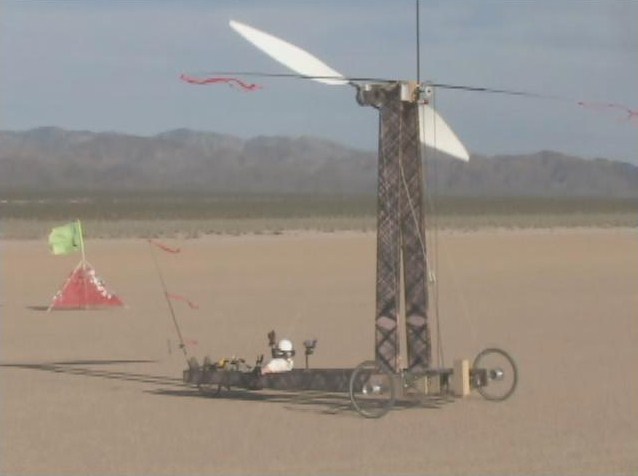 Blackbird traveling downwind faster than the wind, as shown by the streamers on the vehicle and the flag on the ground, pointing in opposite directions.