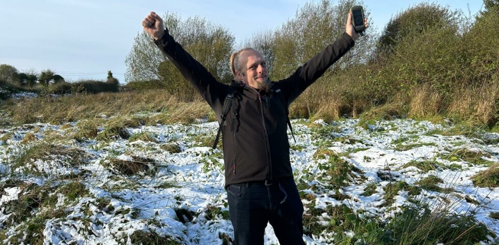 Dan raises his arms in victory.