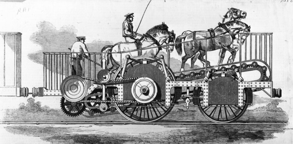 A locomotive featuring four horses climbing an inclined conveyor belt under the supervision of two humans.