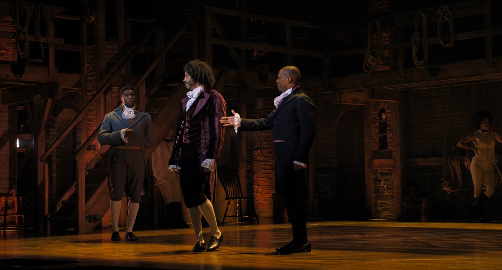 Full image of From the musical Hamilton, Burr offers his hand to Jefferson, who turns his back.
