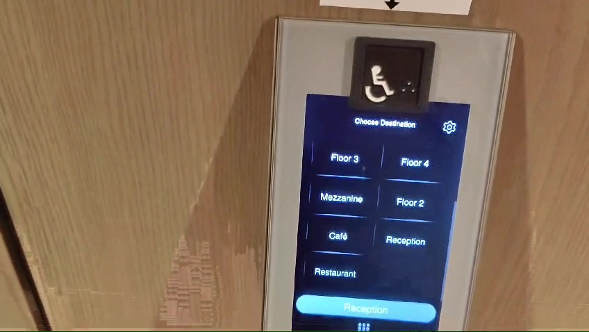 Full image of Touchscreen interface for operating a smart lift, housed in the lobby.