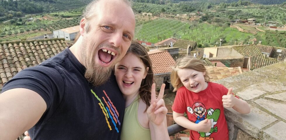 Dan and two kids look excited atop a castle in rural Catalonia.