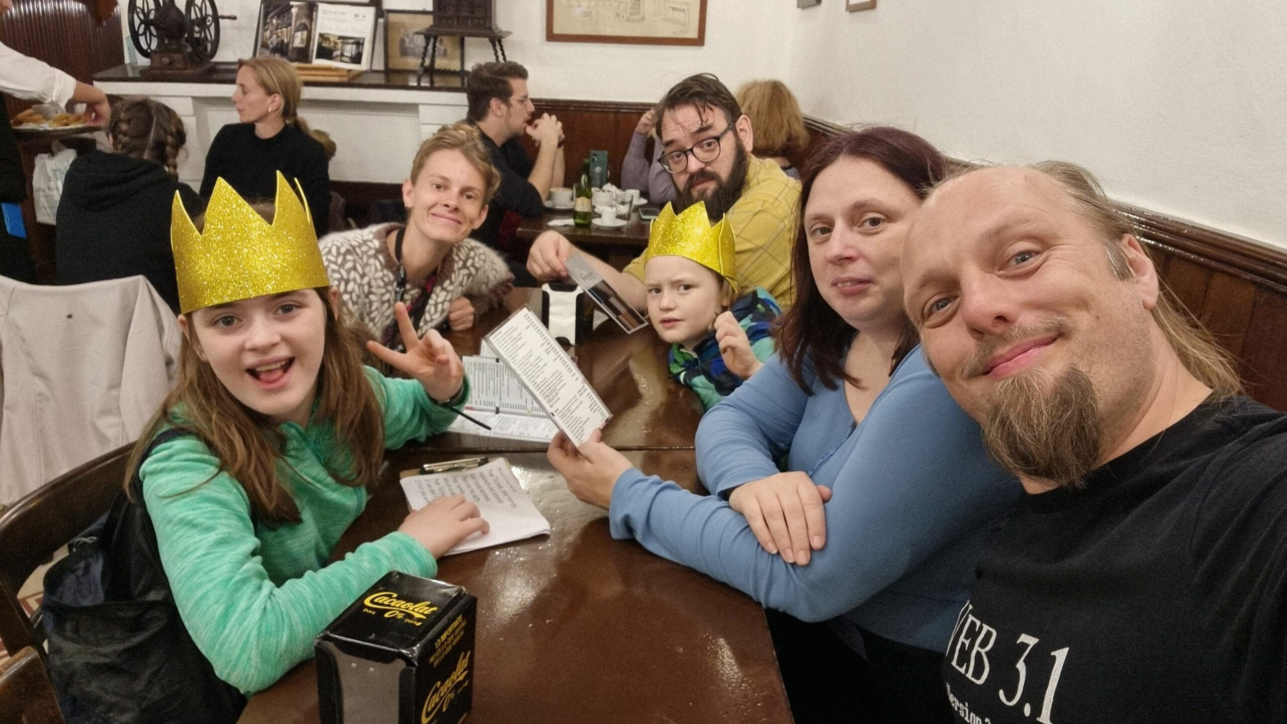 Full image of Dan, Ruth, and JTA with their children and a tour guide called Julie, enjoying churros in a Barcelona cafe.