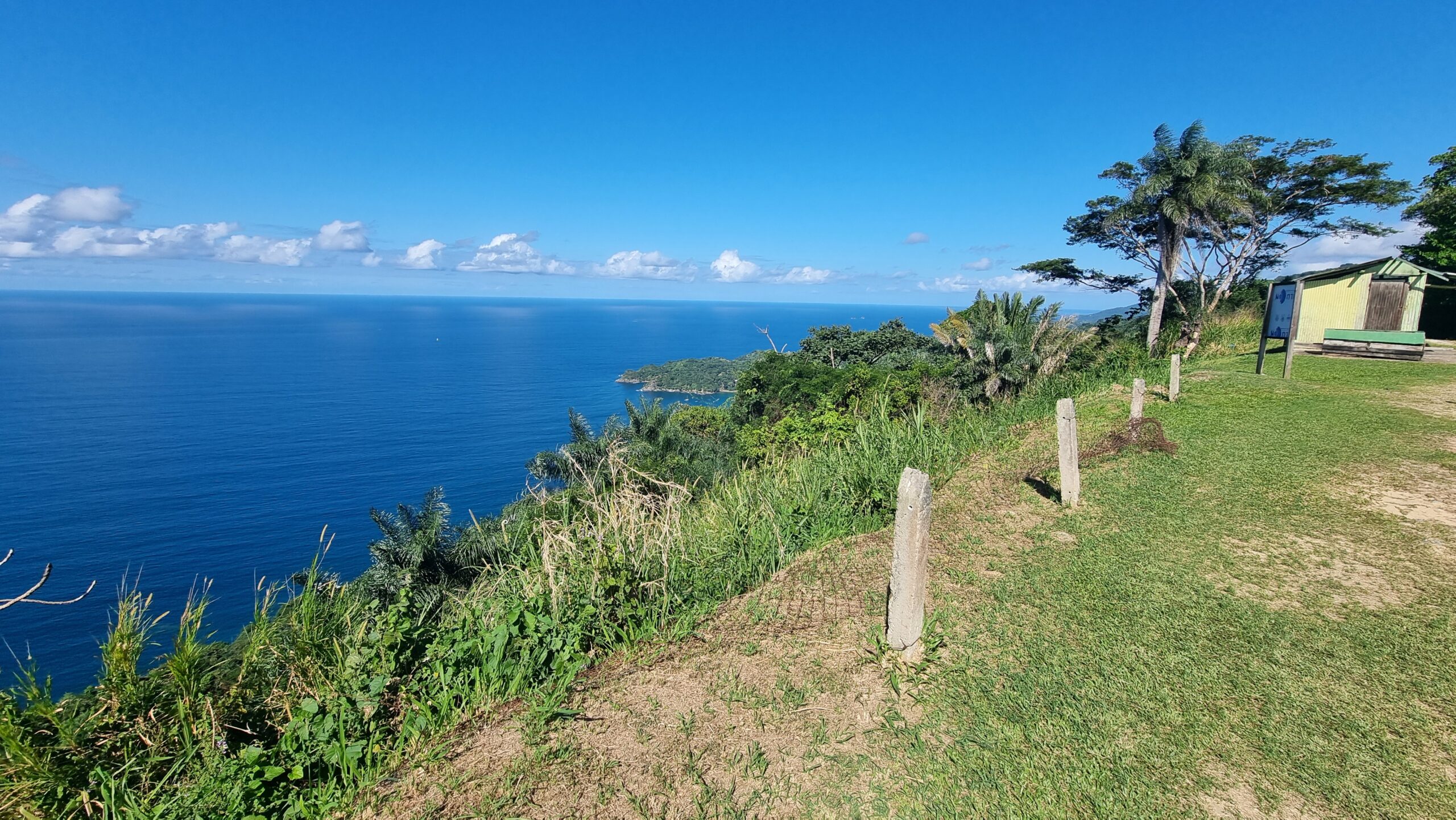 Full image of Tropical cliff view to a bright blue ocean far below.