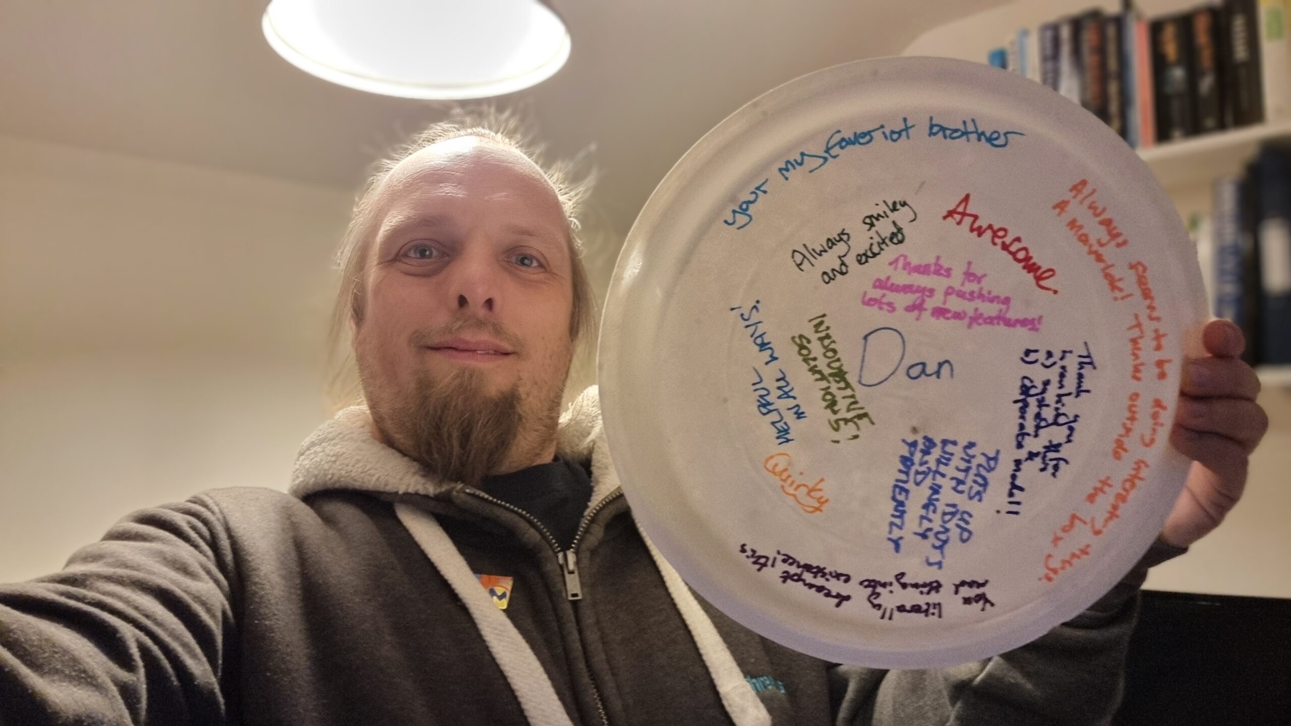 Full image of Dan holding a plate containing his name and a collection of compliments, listed in the full post.