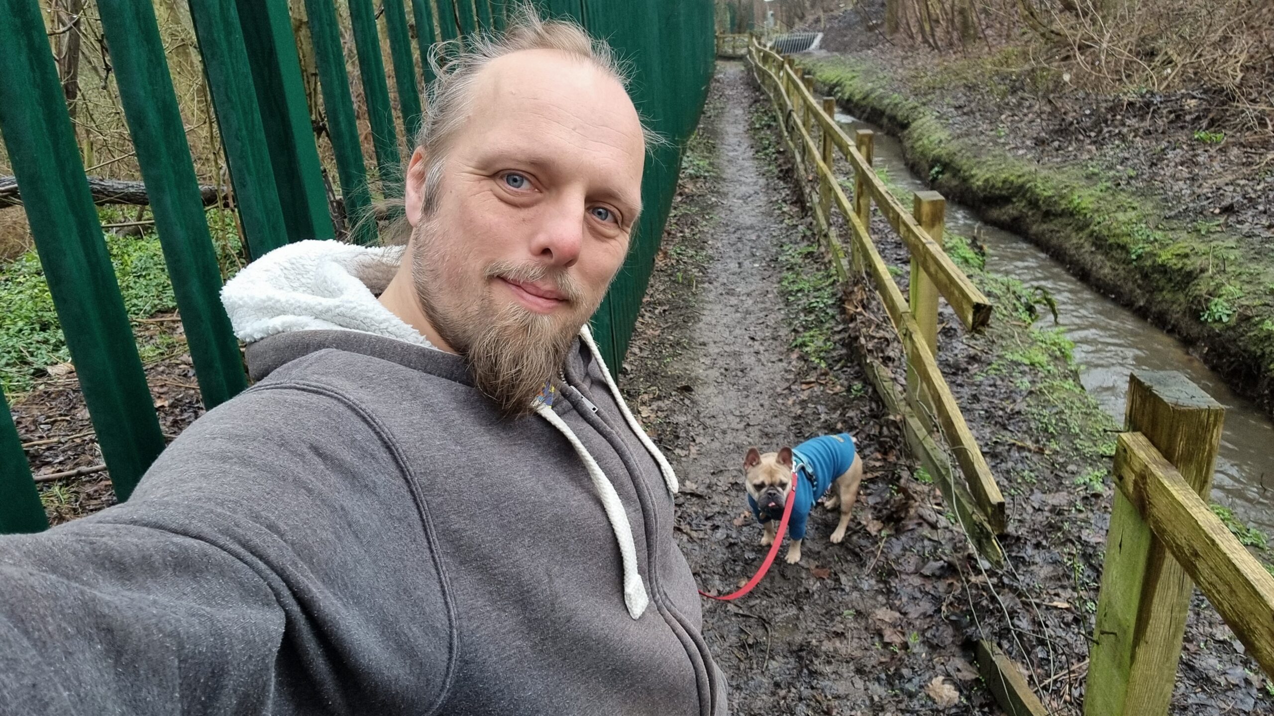 Full image of Dan with his dog on a muddy footpath.
