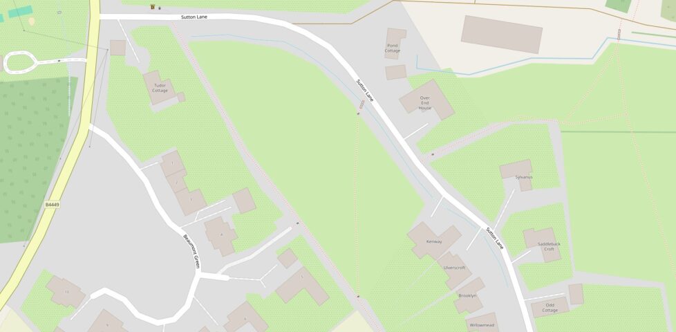 OpenStreetMap view of a rural village, showing named houses, public footpaths criss-crossing around fields, streams, and hedgerows.