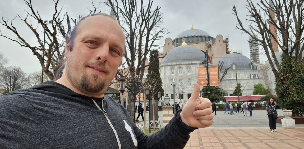 In front of the Hagia Sophia, Dan shoots a 'thumbs up' for a selfie.