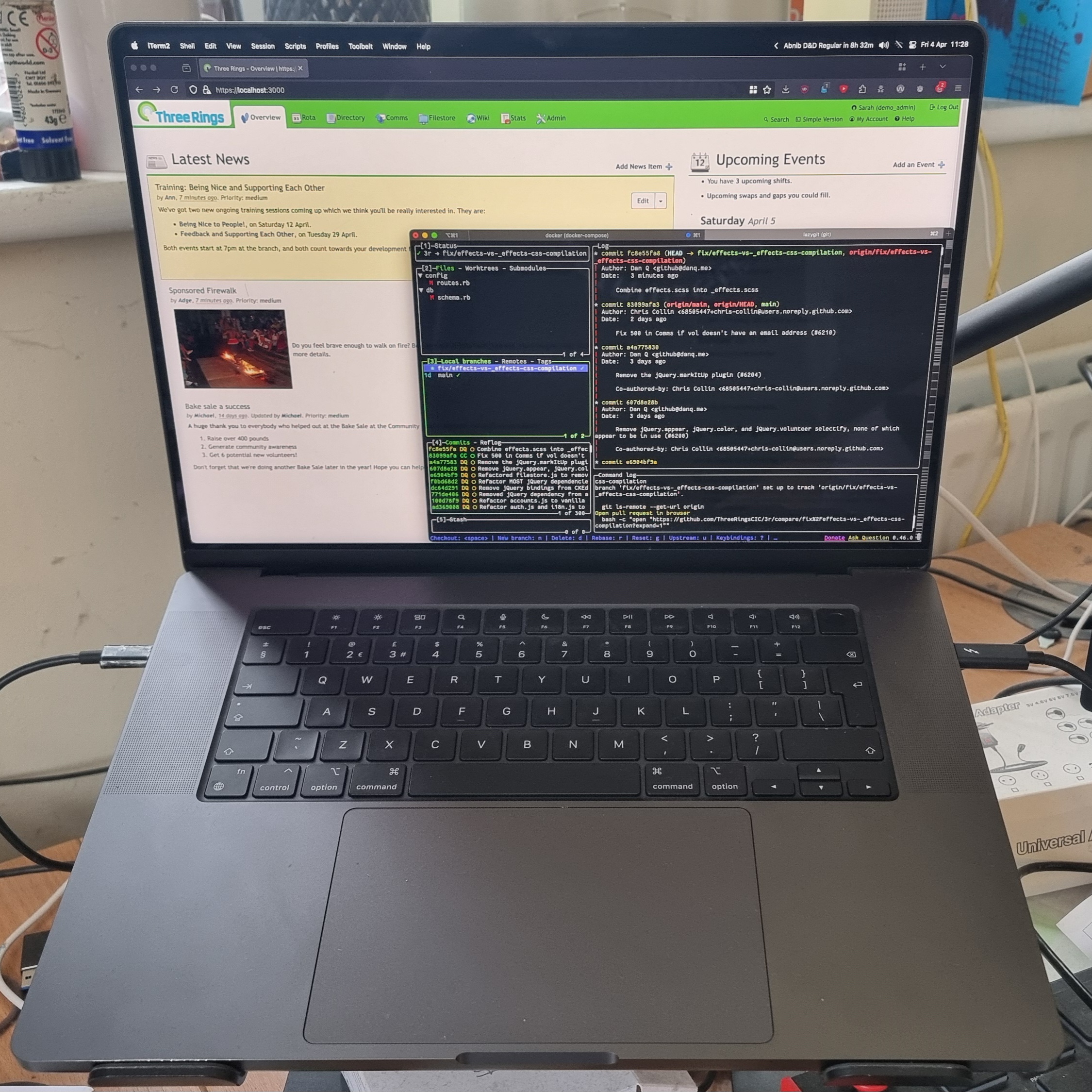 Full image of Black Macbook Pro whose screen shows a locally-hosted copy of the Three Rings web application, overlaid with a terminal running lazygit.