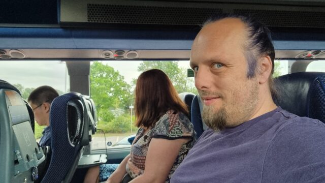Dan, sitting on a bus.