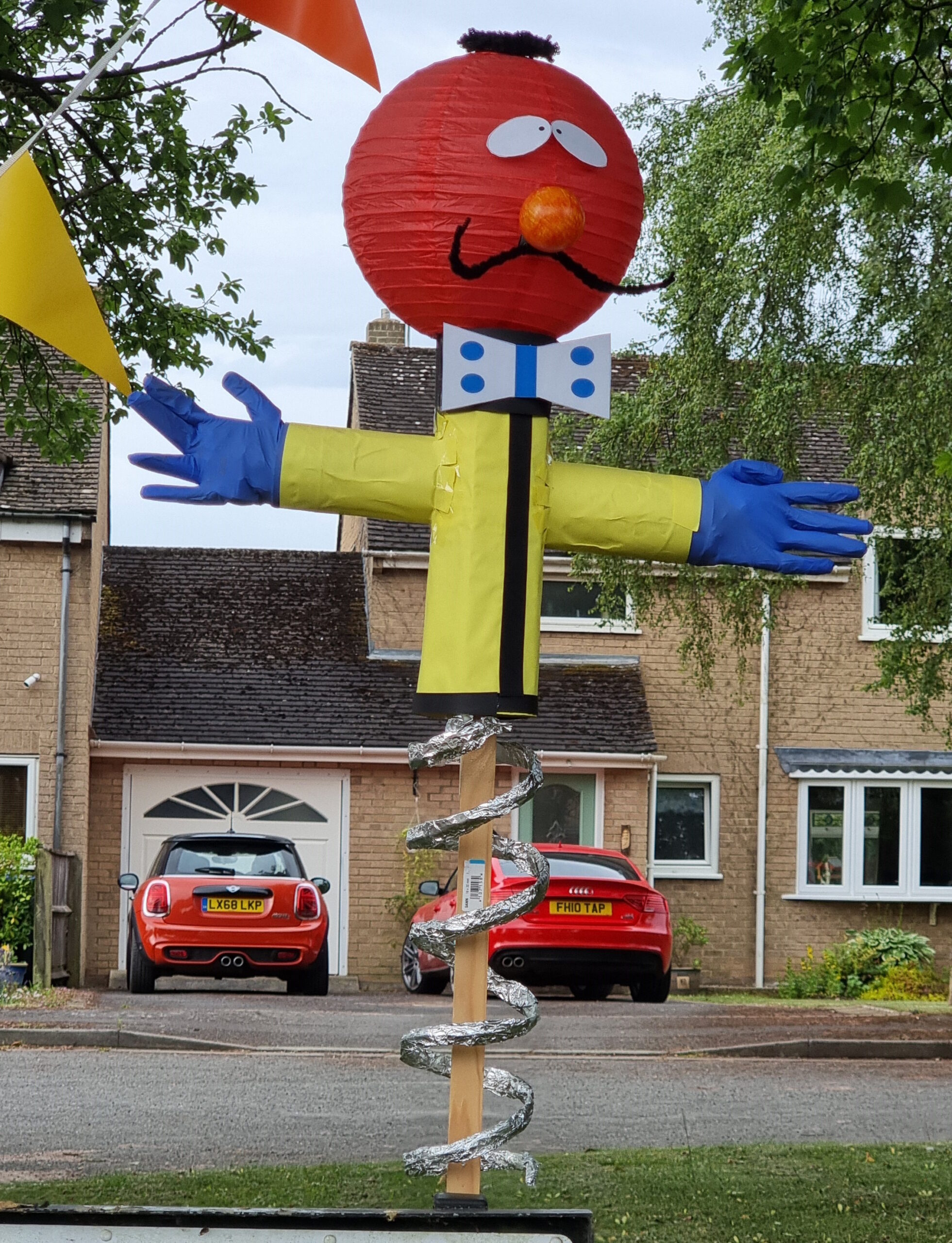 Full image of Red-headed 'thing-on-a-spring' Zebedee, from The Magic Roundabout, in scarecrow form.