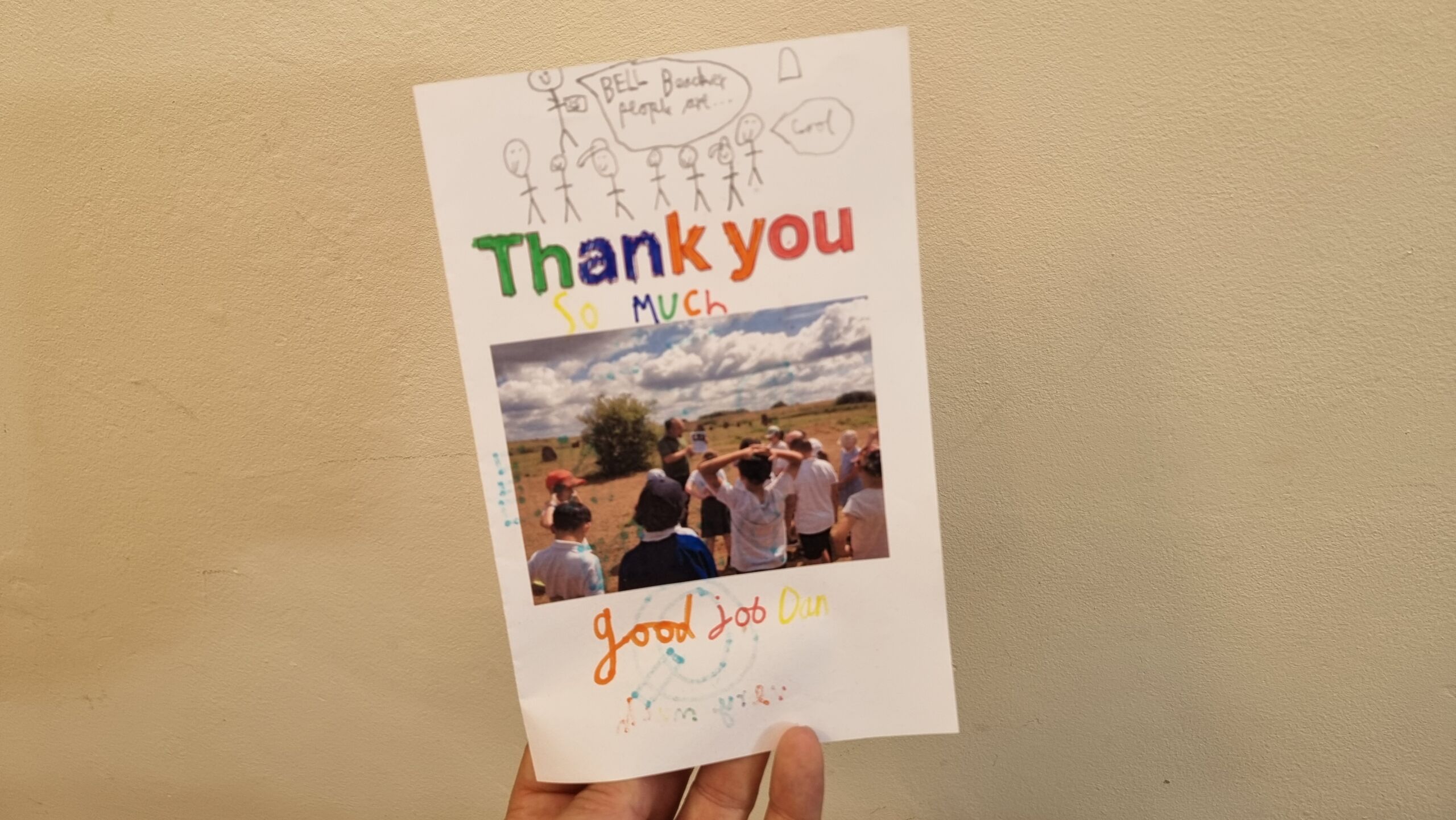 Full image of A hand-coloured card, saying 'Thank you so much', with a child's drawing of somebody talking about Bell Beaker people and a photo of Dan showing pictures of pots to a class of schoolchildren.