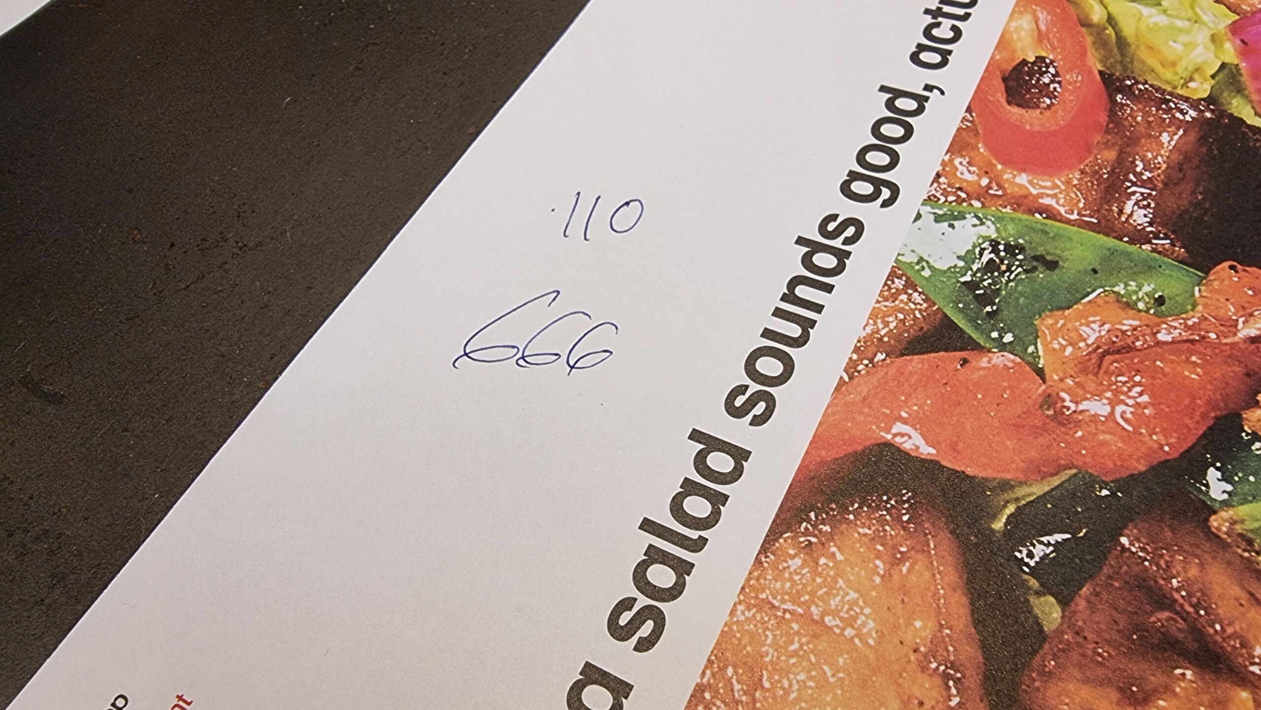 Full image of Wagamama restaturant placemat on which the waitstaff has written my order item numbers: 110, and 666.