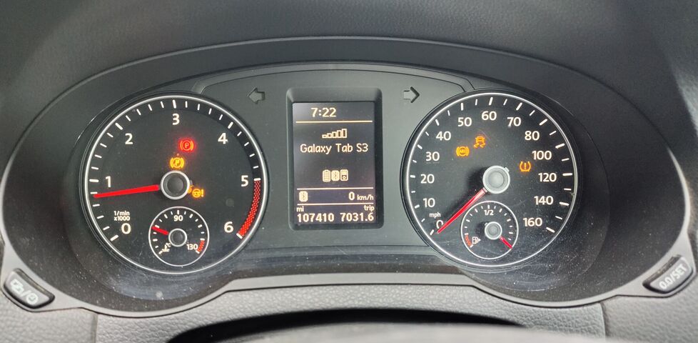 A car dashboard with five amber and one red warning lights lit.