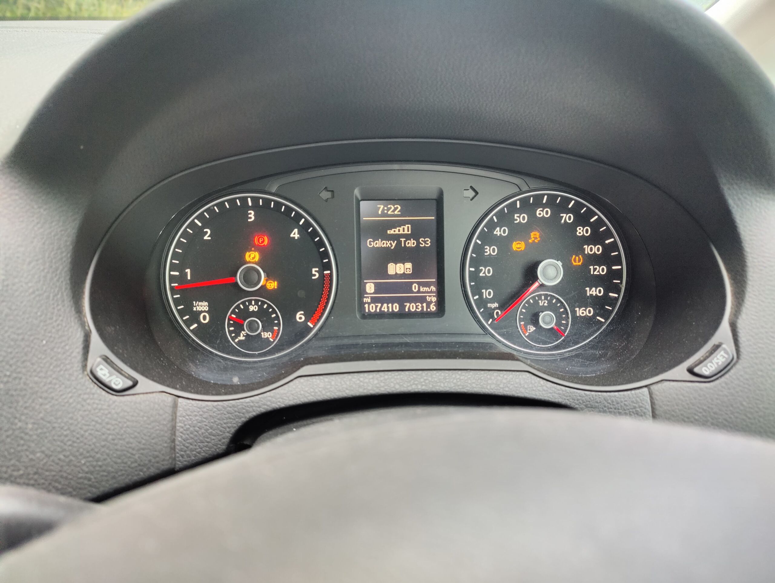 Full image of A car dashboard with five amber and one red warning lights lit.