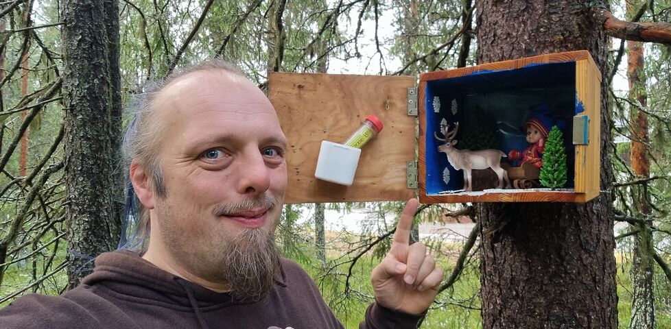 Dan points to an adorable Lapland scene installed in a wooden box attached to a tree.