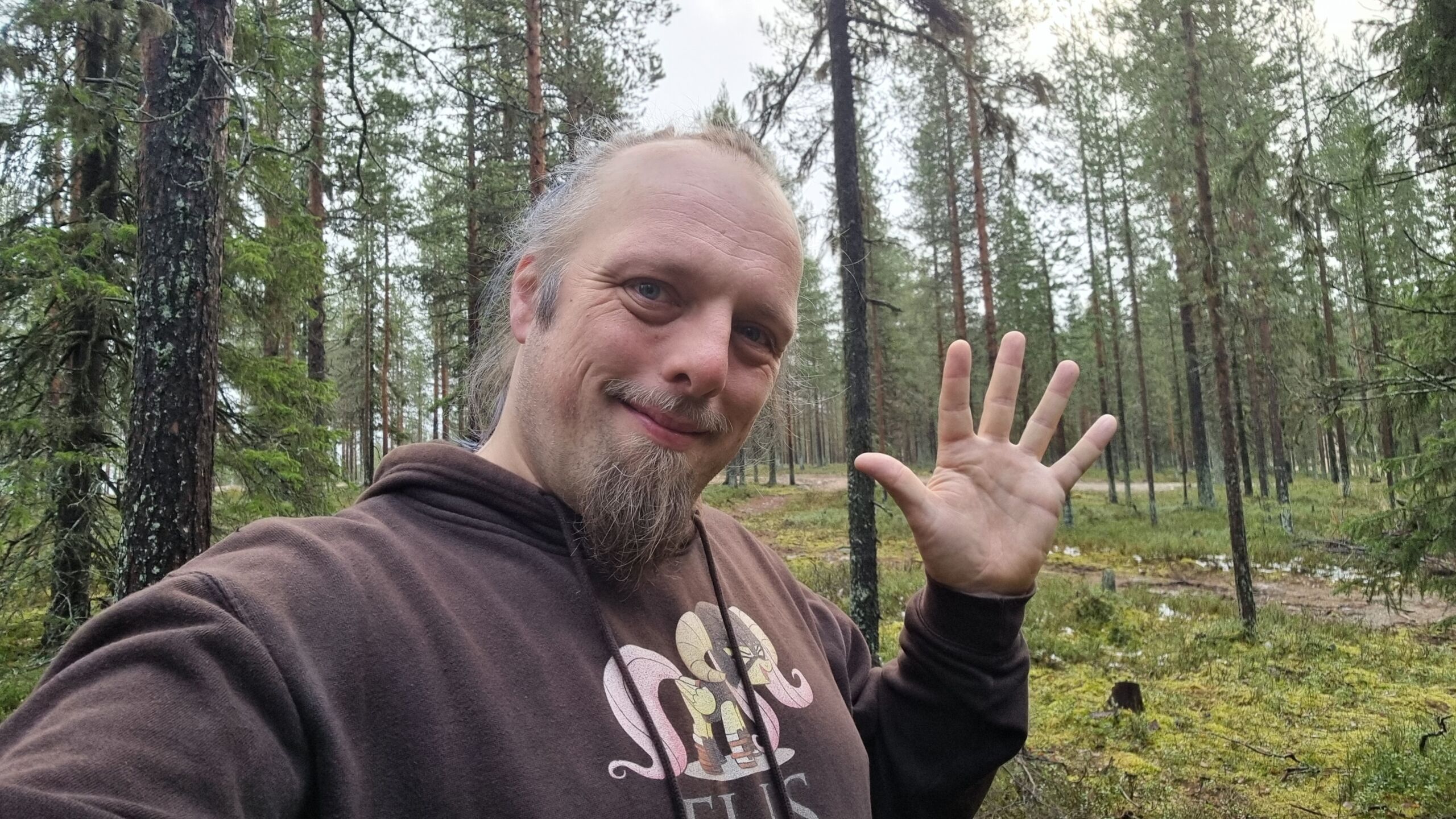 Full image of In a spruce forest, Dan waves.