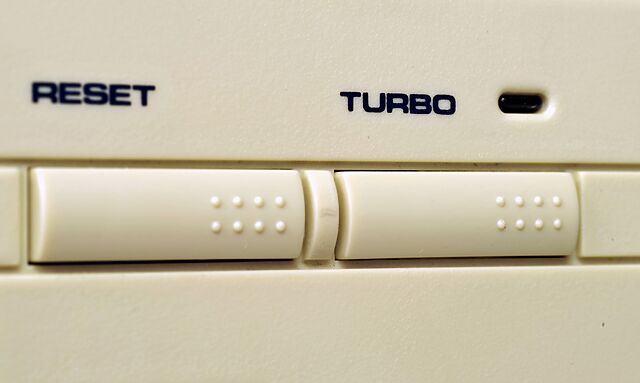 Close-up photo of a computer with reset and turbo buttons in the style mirrored by my component.