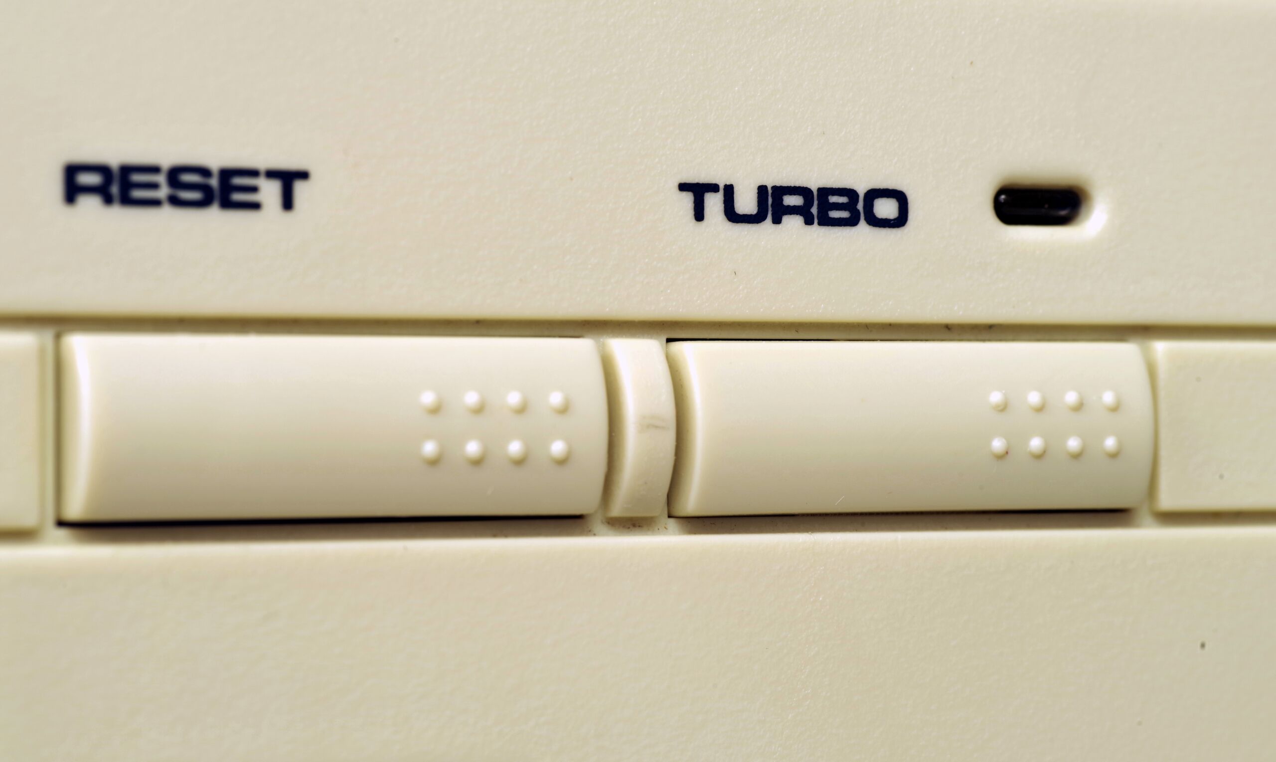 Full image of Close-up photo of a computer with reset and turbo buttons in the style mirrored by my component.