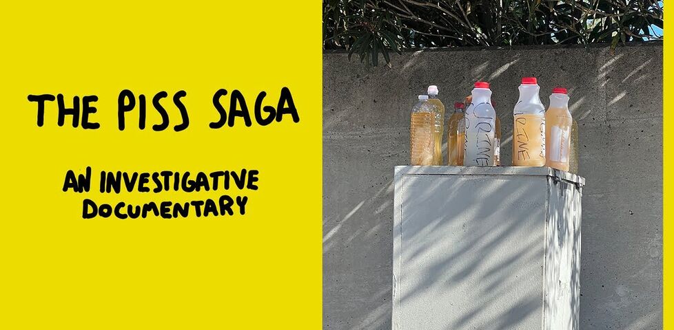 Video thumbnail/title card showing a grey electrical cabinet with several plastic bottles of yellow liquid on top of it, titled "The Piss Saga: an investigative documentary"