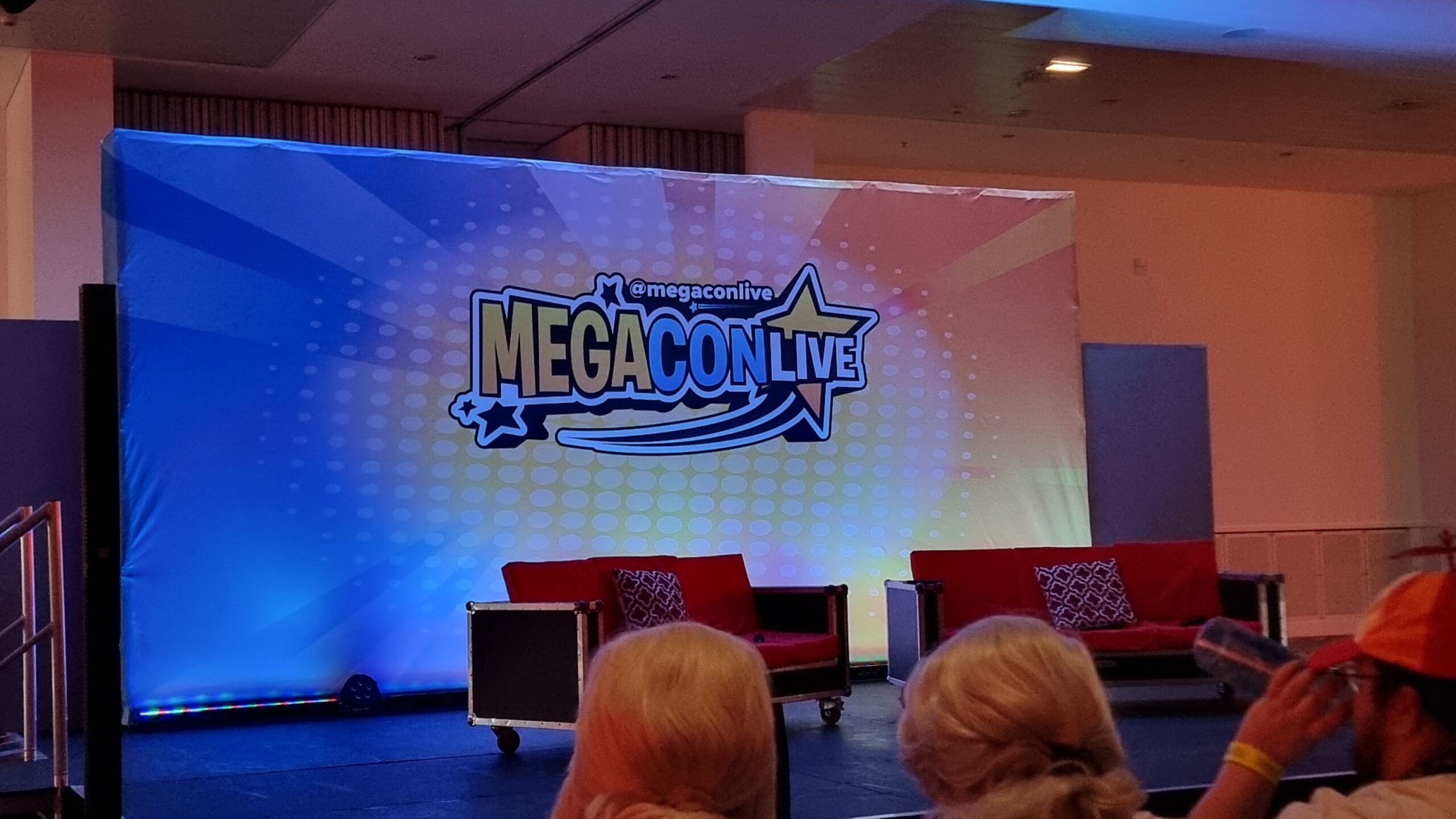 Full image of Convention stage with MegaConLive branding.