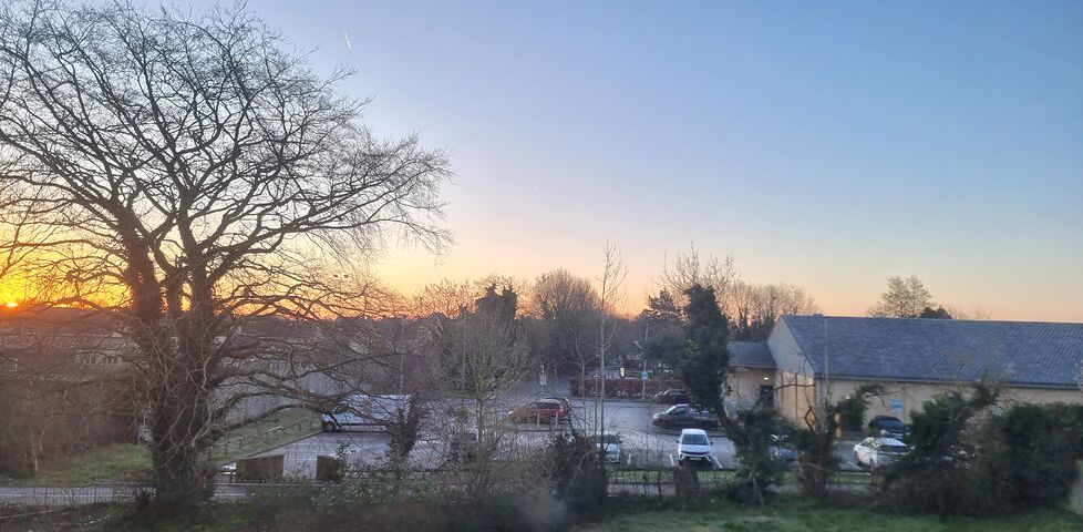 Sun rising through hazy but clear skies. 