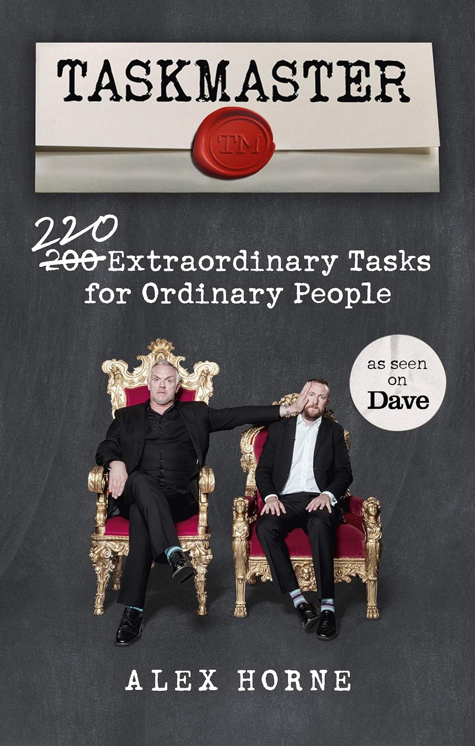 Full image of Cover of Taskmaster: 220 Extraordinary Tasks for Ordinary People, showing author Alex Horne, sitting on a small throne, being pushed in the face by Greg Davies, in a larger throne.