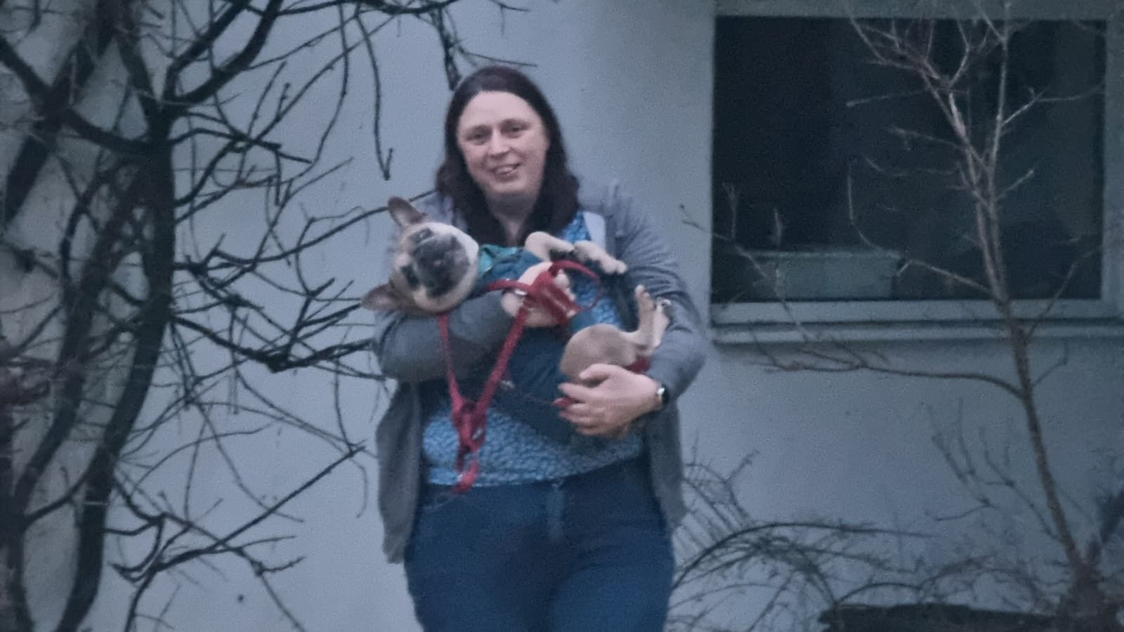 Full image of Close up of the woman carrying the dog.
