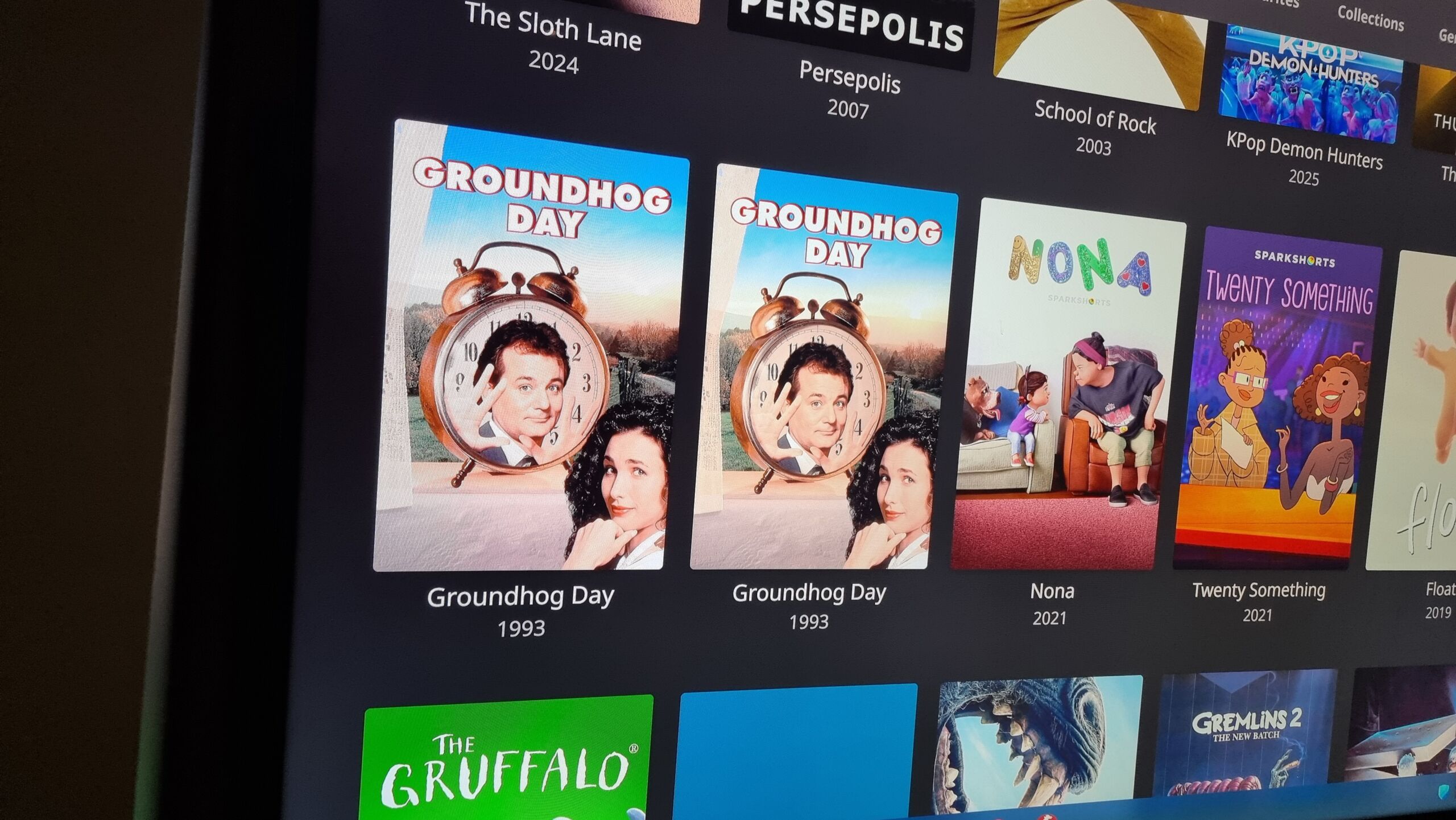 Full image of TV screen interface showing posters for many films. Groundhog Day is listed twice in succession. This is funny because the film is about a celebration date, 'groundhog day', repeating itself.