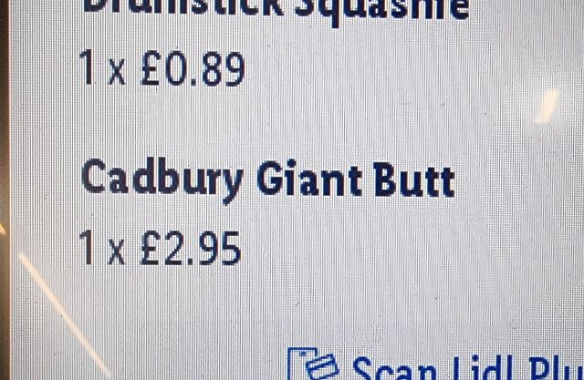 Self-checkout screen abbreviating a product name to 'Cadbury Giant Butt'.