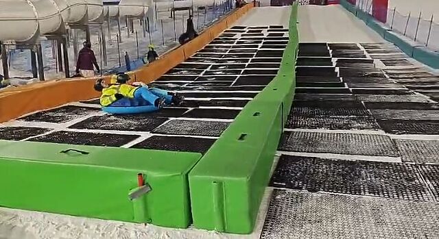 Ring riders on an indoor ski slope.