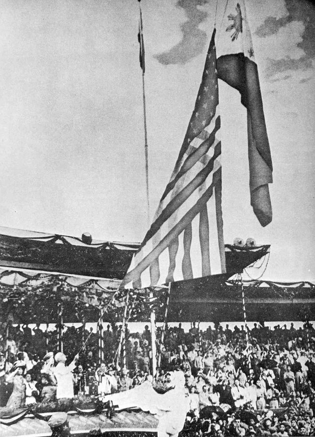 The US flag is lowered and the Philippine flag is raised.