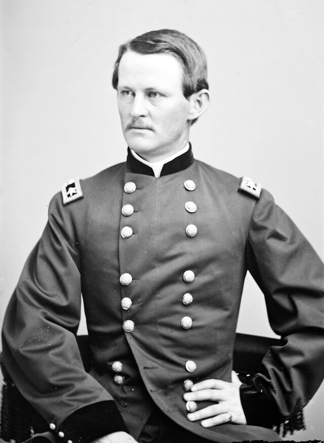 Portrait photograph of a young white man in military uniform.