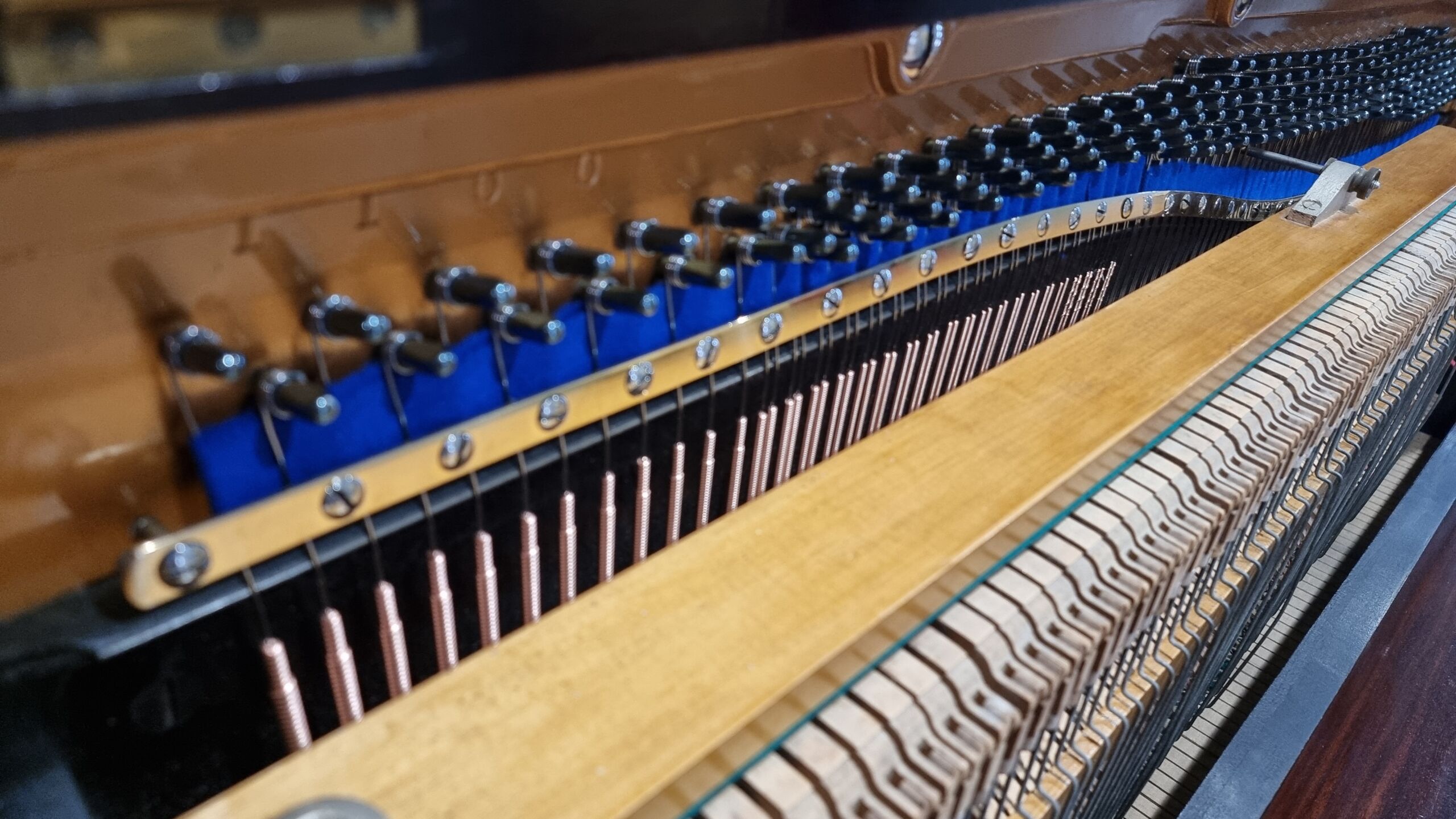 Full image of The pristine inside of an upright piano.