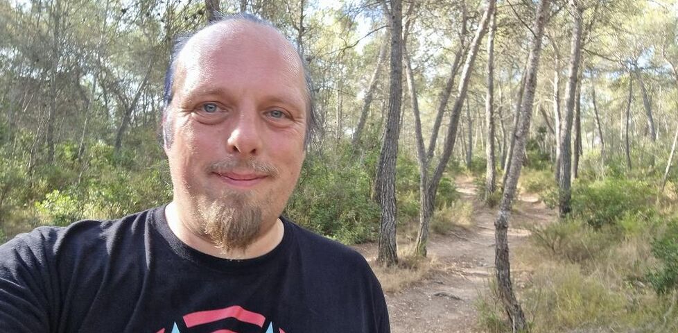 Dan, sweating, on a forest trail.