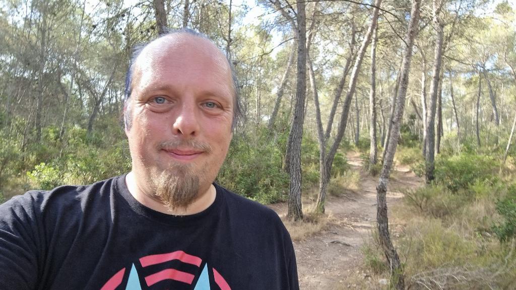 Full image of Dan, sweating, on a forest trail.