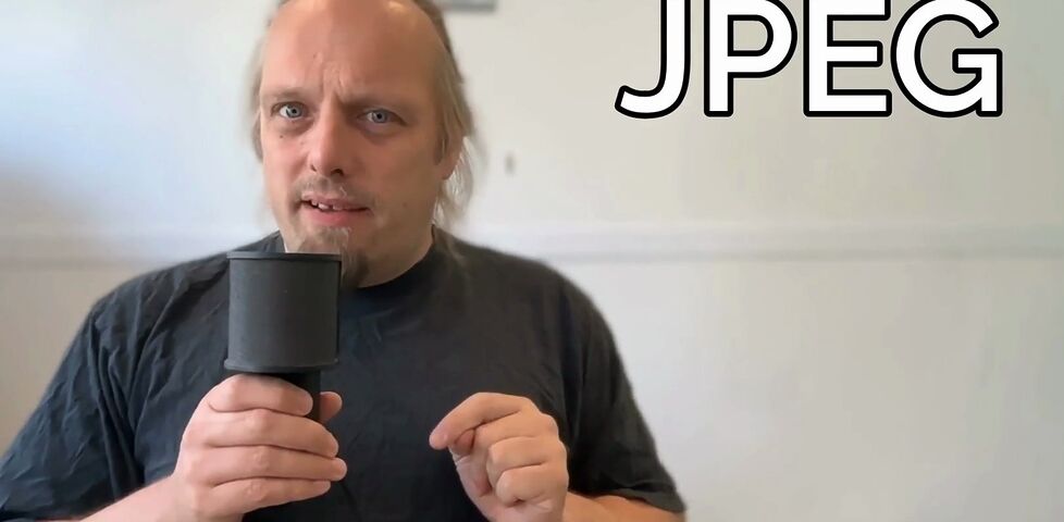 Dan holds a microphone alongside the word 'JPEG'.