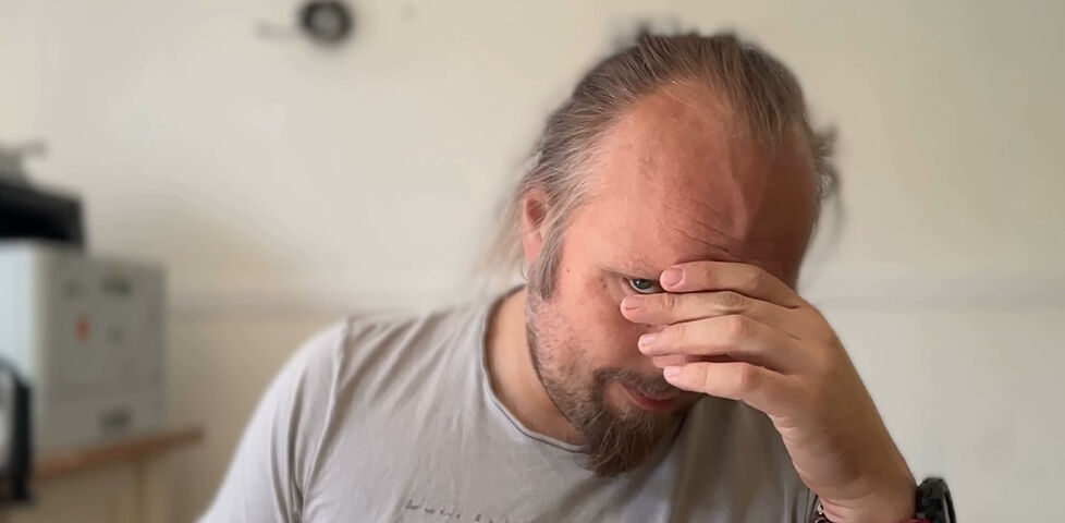 Dan, a white man with a goatee beard, looks despairing as he slowly shakes his head.