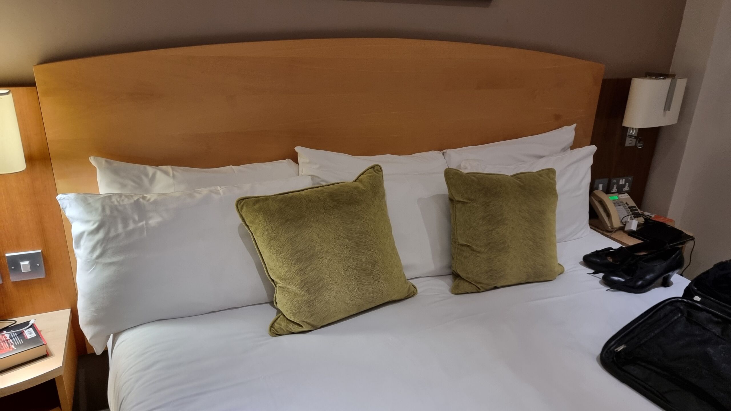 Full image of Wide bed with three sets of pillows laid out.