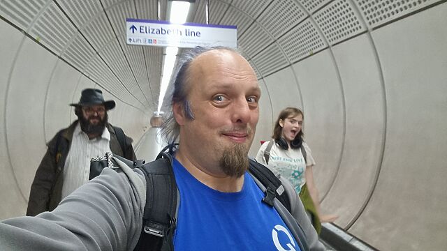 Dan is accompanied by his team in a subterranean tunnel signposted "Elizabeth Line".