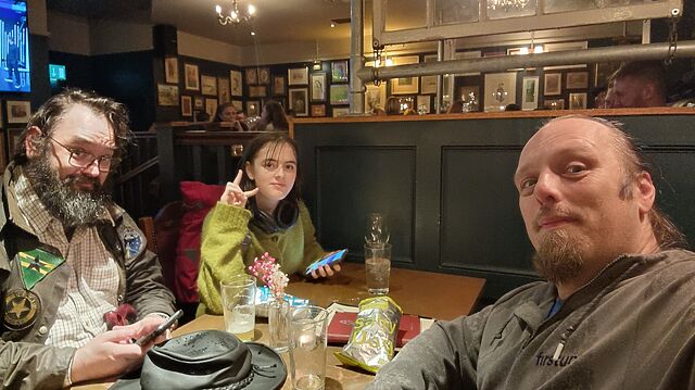 The new hiding team sits in a pub.