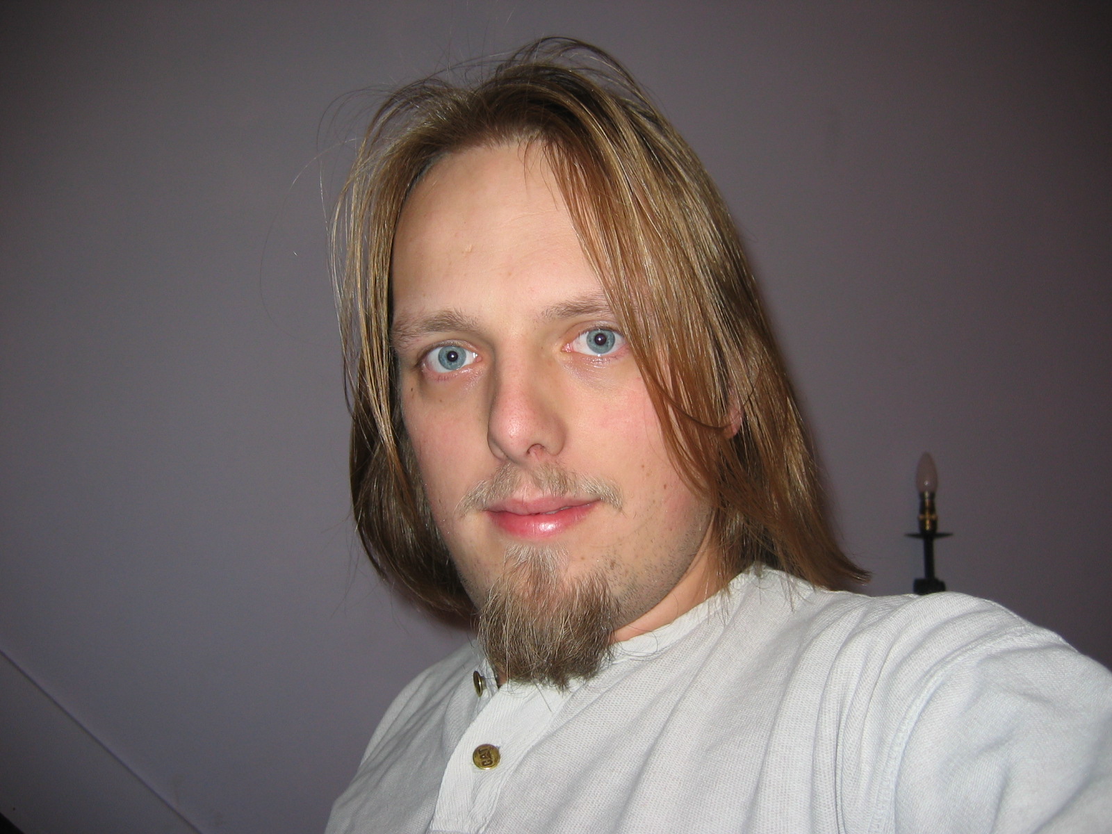 Full image of Dan with his hair just-above the shoulder.